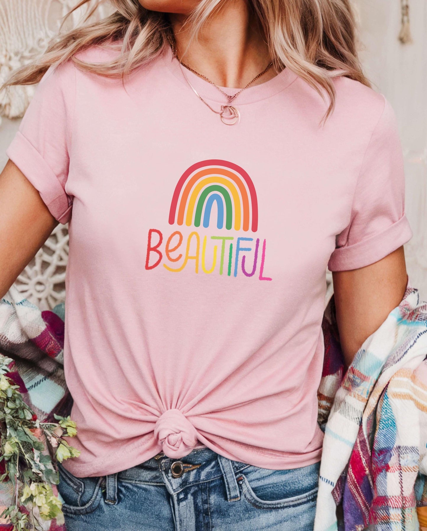 Light pink rainbow t-shirt with colorful “Beautiful” text, styled with plaid outerwear. Feminine LGBTQ+ pride tee, pastel pride shirt, rainbow self-love fashion.
