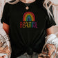 Knotted black t-shirt with rainbow “Beautiful” text, worn with light-wash jeans and cozy cardigan. Affirmation shirt for women, empowering LGBTQ+ shirt, uplifting pride apparel.