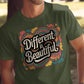 Man wearing a military green t-shirt with a colorful graphic that reads “Different is Beautiful” in bold, retro-style white lettering. The design features swirls and hearts in vibrant teal, pink, mustard, and orange. This bold shirt is a colorful graphic tee and positive quote tee, perfect for those who want a stand out shirt with a custom graphic print. A unique statement tee and inspirational shirt that doubles as a self love t shirt and emotional shirt.